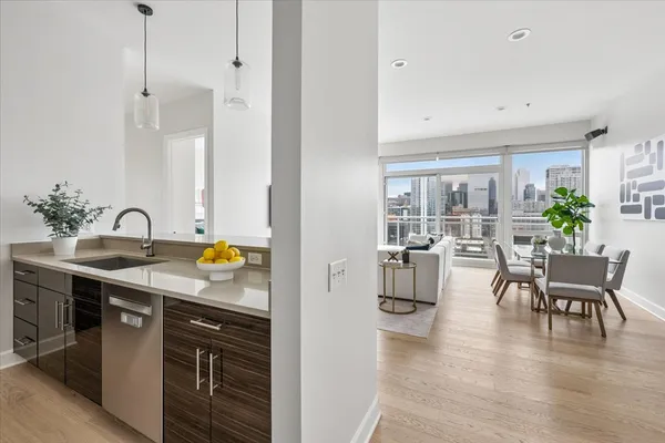 a kitchen with a table chairs refrigerator and cabinets