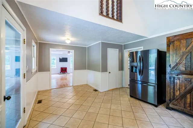 a view of kitchen with furniture and refrigerator