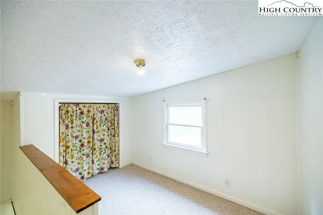 a view of a house with swimming pool and sitting area
