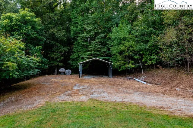 a view of a house with swimming pool and sitting area