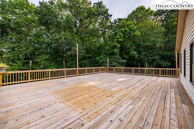 a view of an empty room with cabinet and a window
