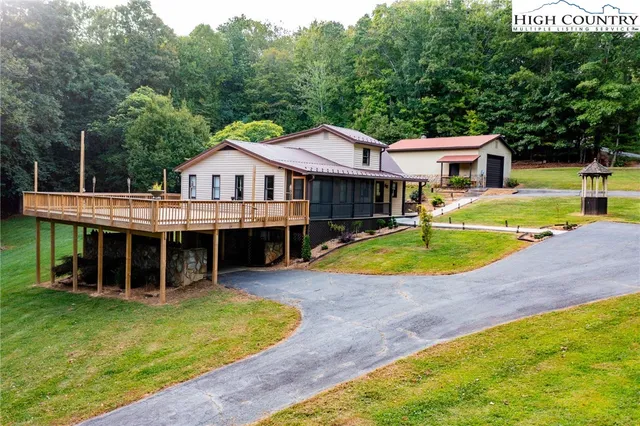 a view of a house with swimming pool and a yard