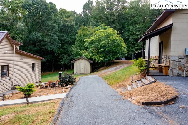 an aerial view of a house with a yard and garden