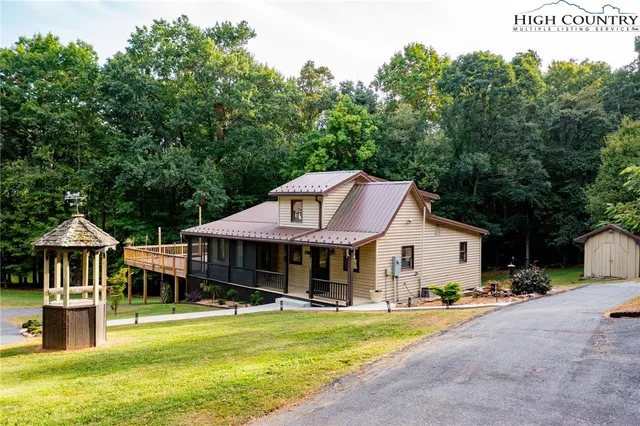 an aerial view of a house with swimming pool garden view and a yard