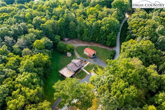 a view of a patio with table and chairs a barbeque with wooden floor
