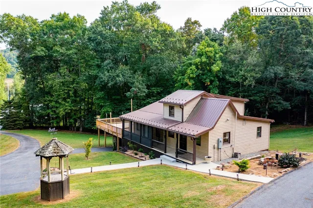 a view of a house with a backyard and a patio