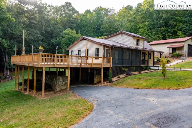 a view of a house with a yard porch and sitting area