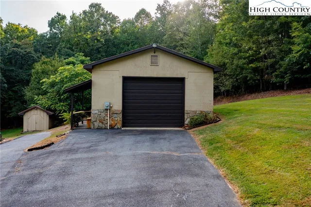 a view of backyard of house and trees
