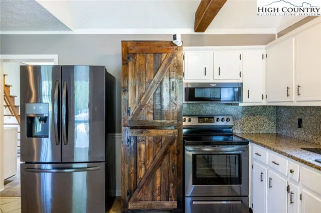a kitchen with appliances a sink and cabinets
