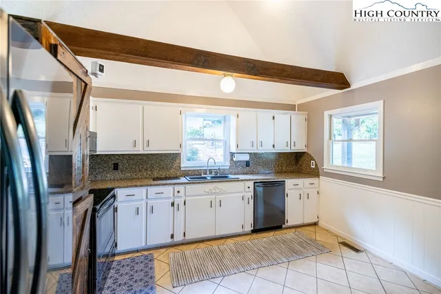 a kitchen with stainless steel appliances a stove sink and cabinets