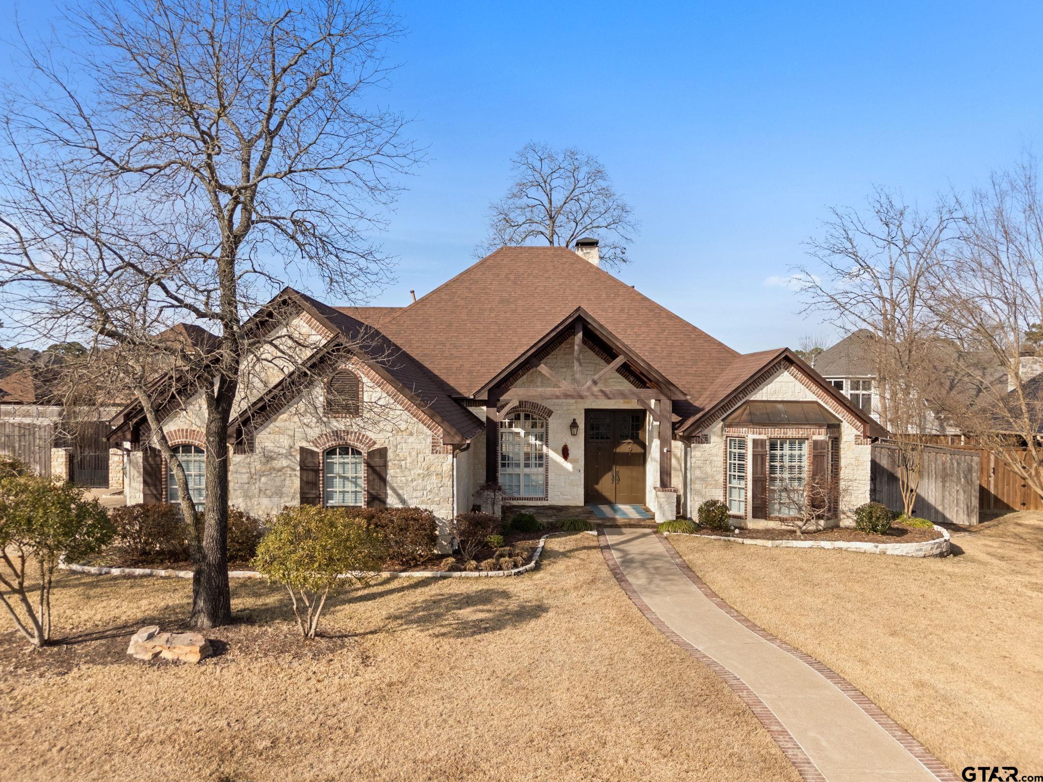 2306 Kingsmill Circle Tyler, TX 75703 - Photo 13 of 37 a front view of a house with a yard covered with snow in front of house