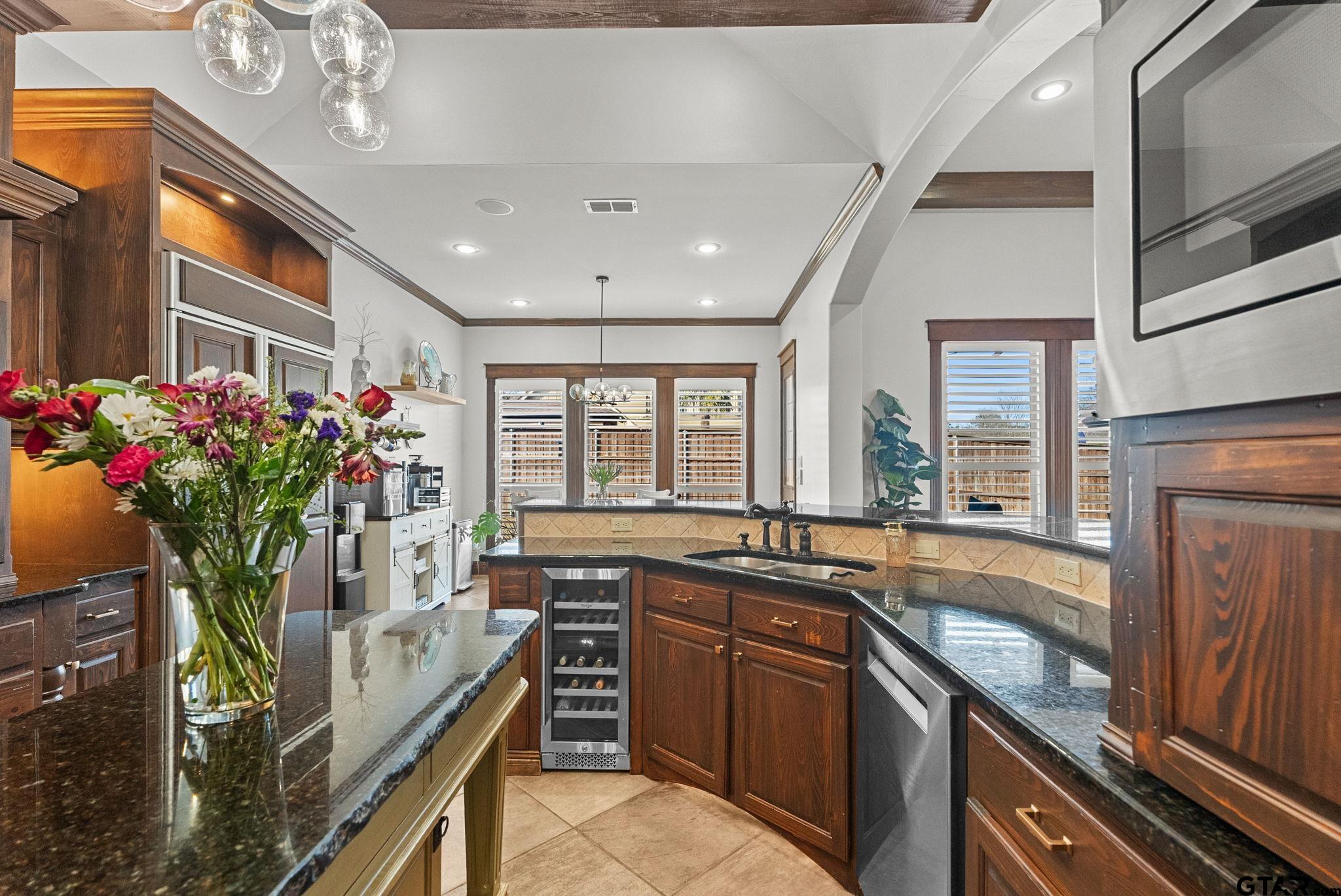 2306 Kingsmill Circle Tyler, TX 75703 - Photo 24 of 37 a kitchen with stainless steel appliances granite countertop a sink stove and cabinets