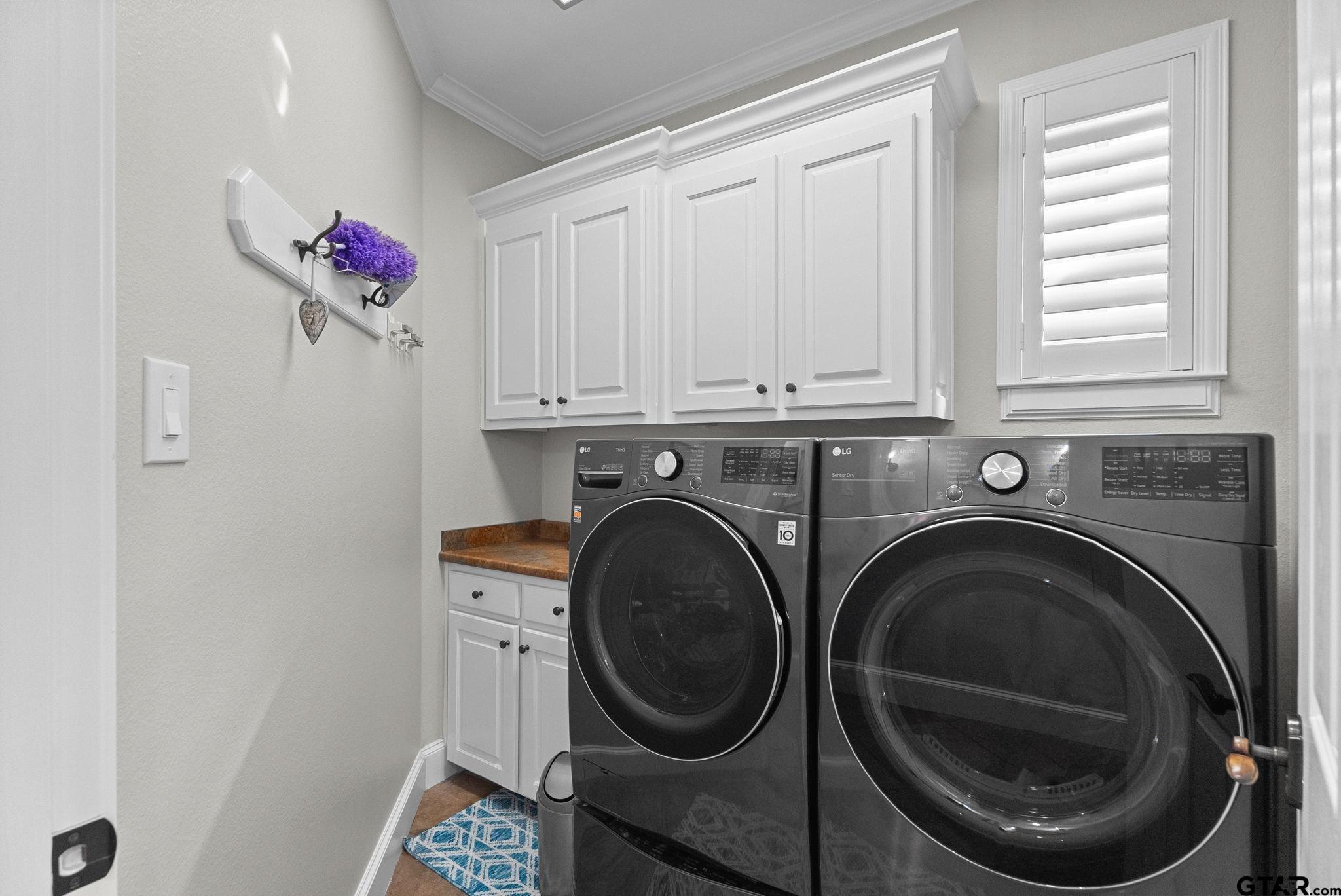 2306 Kingsmill Circle Tyler, TX 75703 - Photo 31 of 37 a utility room with dryer and washer