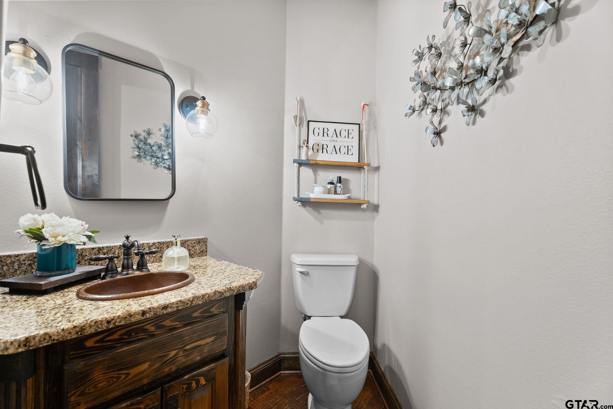 2306 Kingsmill Circle Tyler, TX 75703 - Photo 32 of 37 a bathroom with a granite countertop toilet sink and mirror