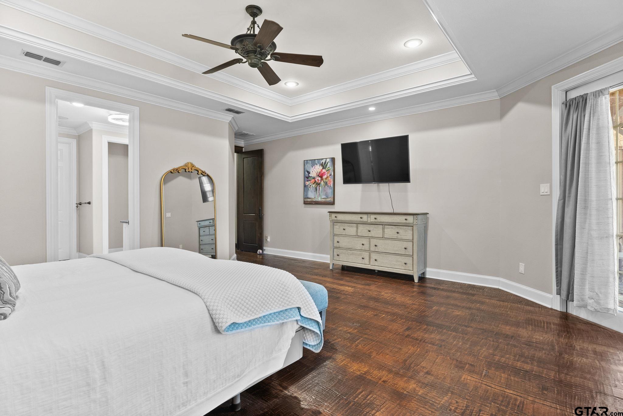 2306 Kingsmill Circle Tyler, TX 75703 - Photo 5 of 37 a spacious bedroom with a bed and a flat screen tv