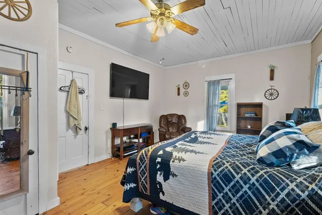 a bedroom that has a bed and a flat screen tv