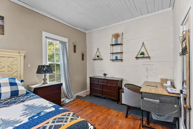 a bedroom with furniture and a window