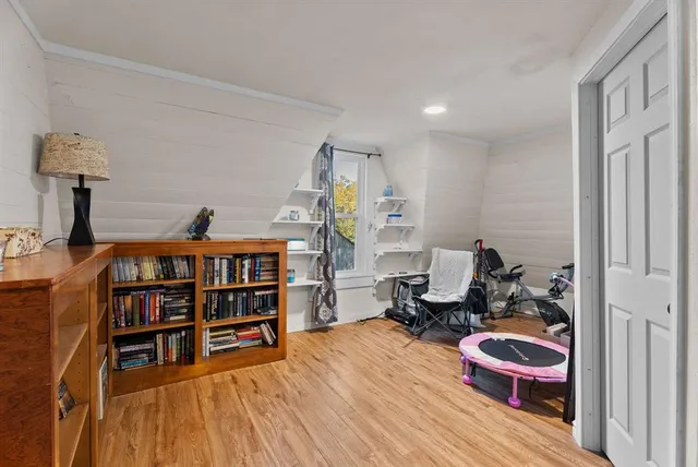 a bedroom with furniture and wooden floor