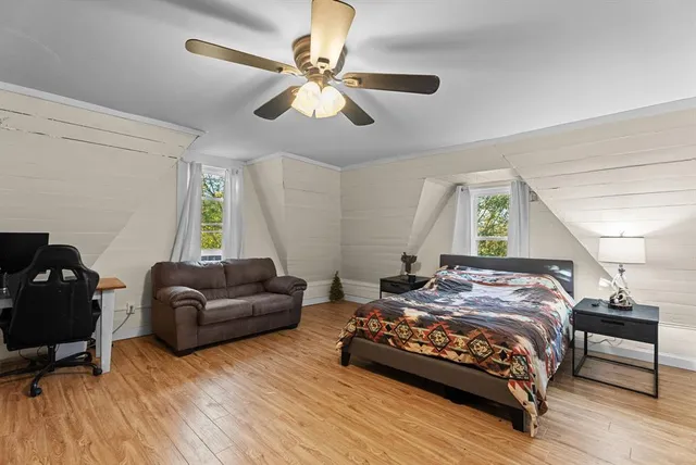 a bedroom with a bed couch and a window