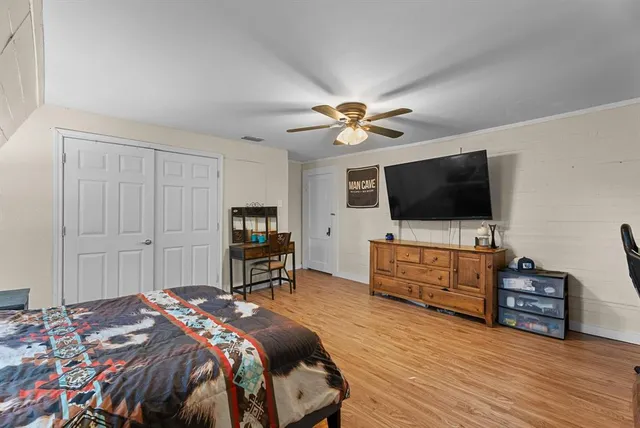 a bedroom with a bed and a flat screen tv