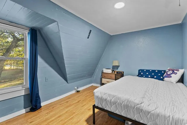 a bedroom with two beds and a window