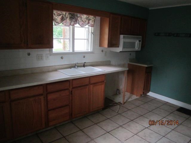 210 East Brayton Road Mount Morris, IL 61054 - Photo 8 of 11 a kitchen with a sink cabinets and a window