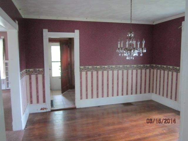 210 East Brayton Road Mount Morris, IL 61054 - Photo 9 of 11 a view of an empty room with wooden floor and fan
