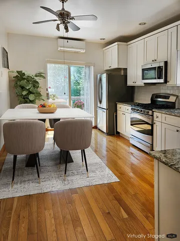 a kitchen with sink a refrigerator and chairs