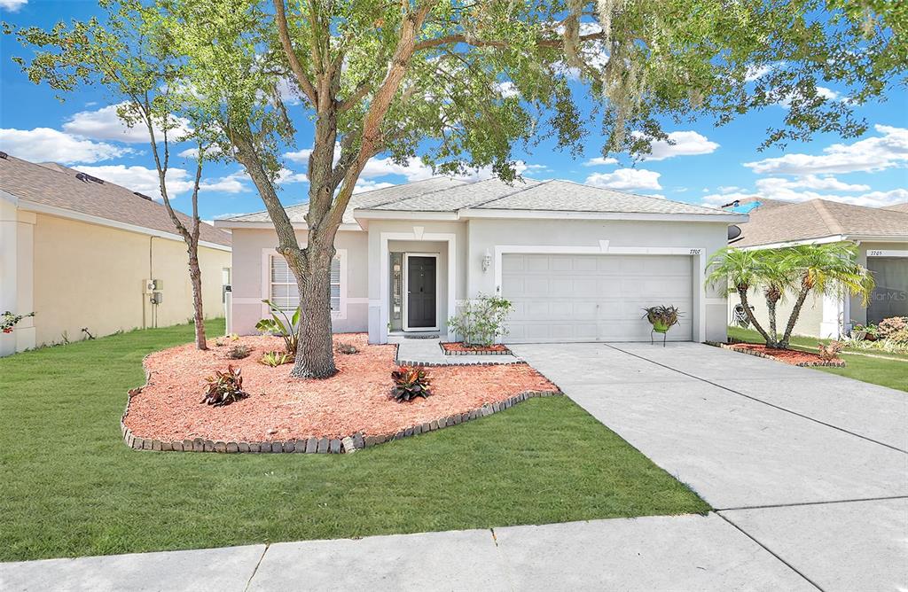 a view of a house with backyard and sitting area