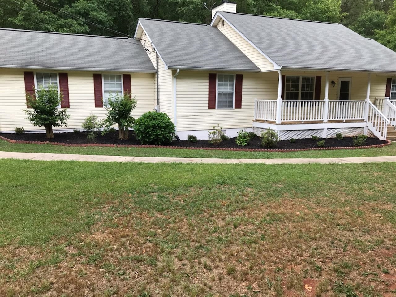 101 North Rover Road Williamson, GA 30292 - Photo 1 of 1 a front view of a house with a yard and potted plants