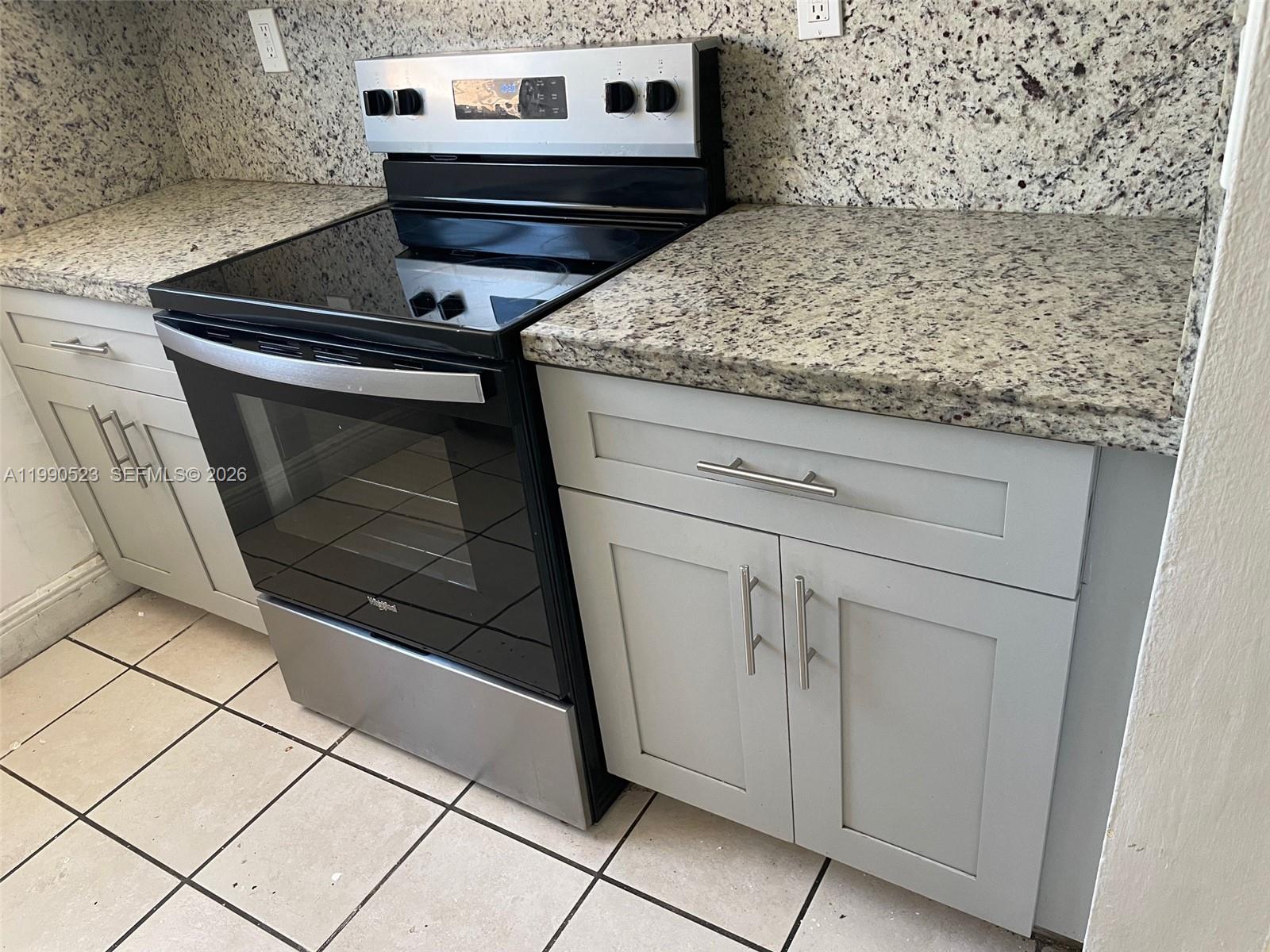 1787 Southwest 7th Street, Unit 7 Miami, FL 33135 - Photo 4 of 9 a stove top oven sitting inside of a kitchen