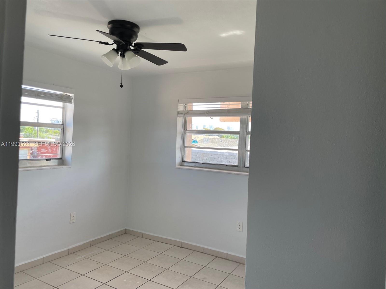 1787 Southwest 7th Street, Unit 7 Miami, FL 33135 - Photo 6 of 9 an empty room with a window and a fan