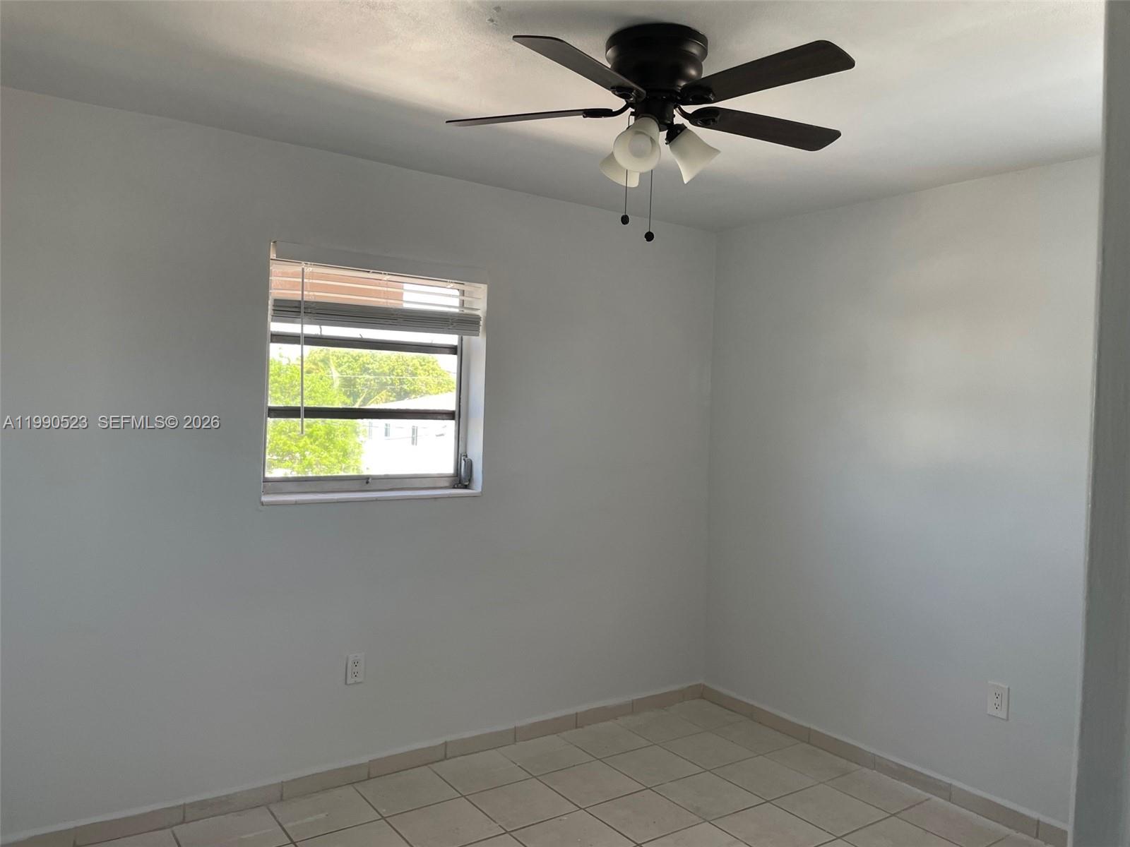 1787 Southwest 7th Street, Unit 7 Miami, FL 33135 - Photo 7 of 9 an empty room with a window