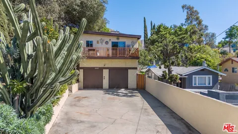 a front view of a house with a yard and an outdoor seating