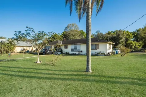 a house with green field in front of it
