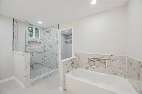 a bathroom with a bathtub and a shower