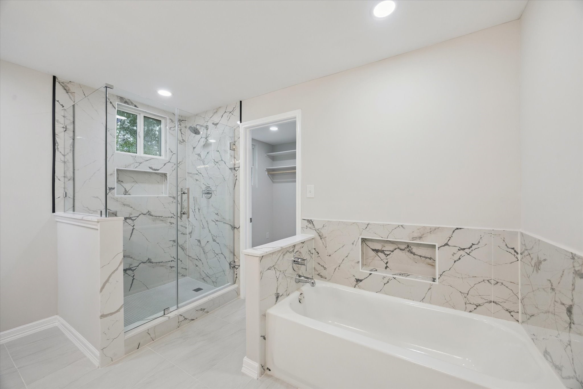10009 Lazy Oaks Street Houston, TX 77080 - Photo 14 of 23 a bathroom with a bathtub and a shower