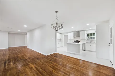 a open kitchen with kitchen island white cabinets and refrigerator