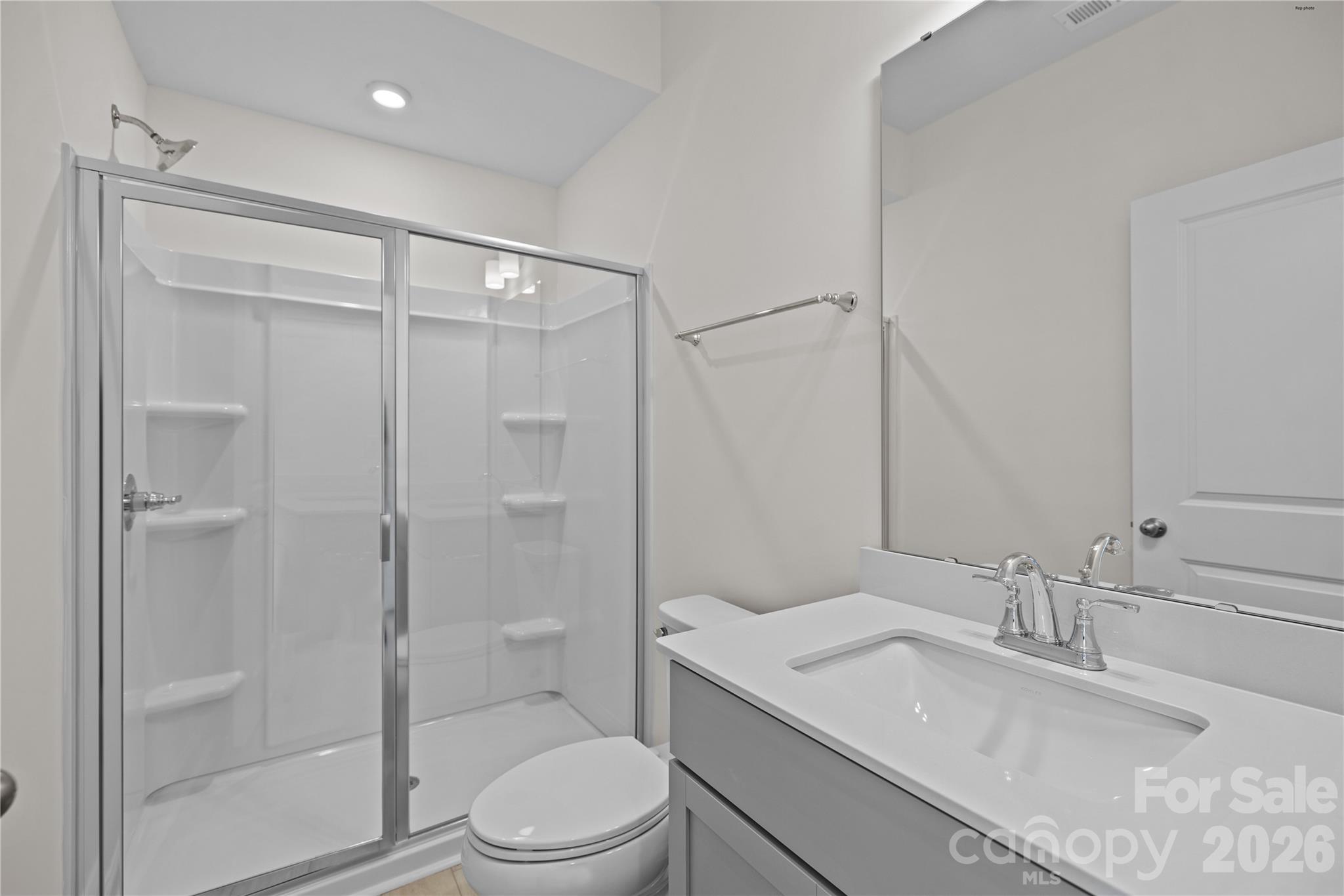 3027 Rozzelles Ferry Road Charlotte, NC 28208 - Photo 12 of 16 a bathroom with a granite countertop sink toilet and shower