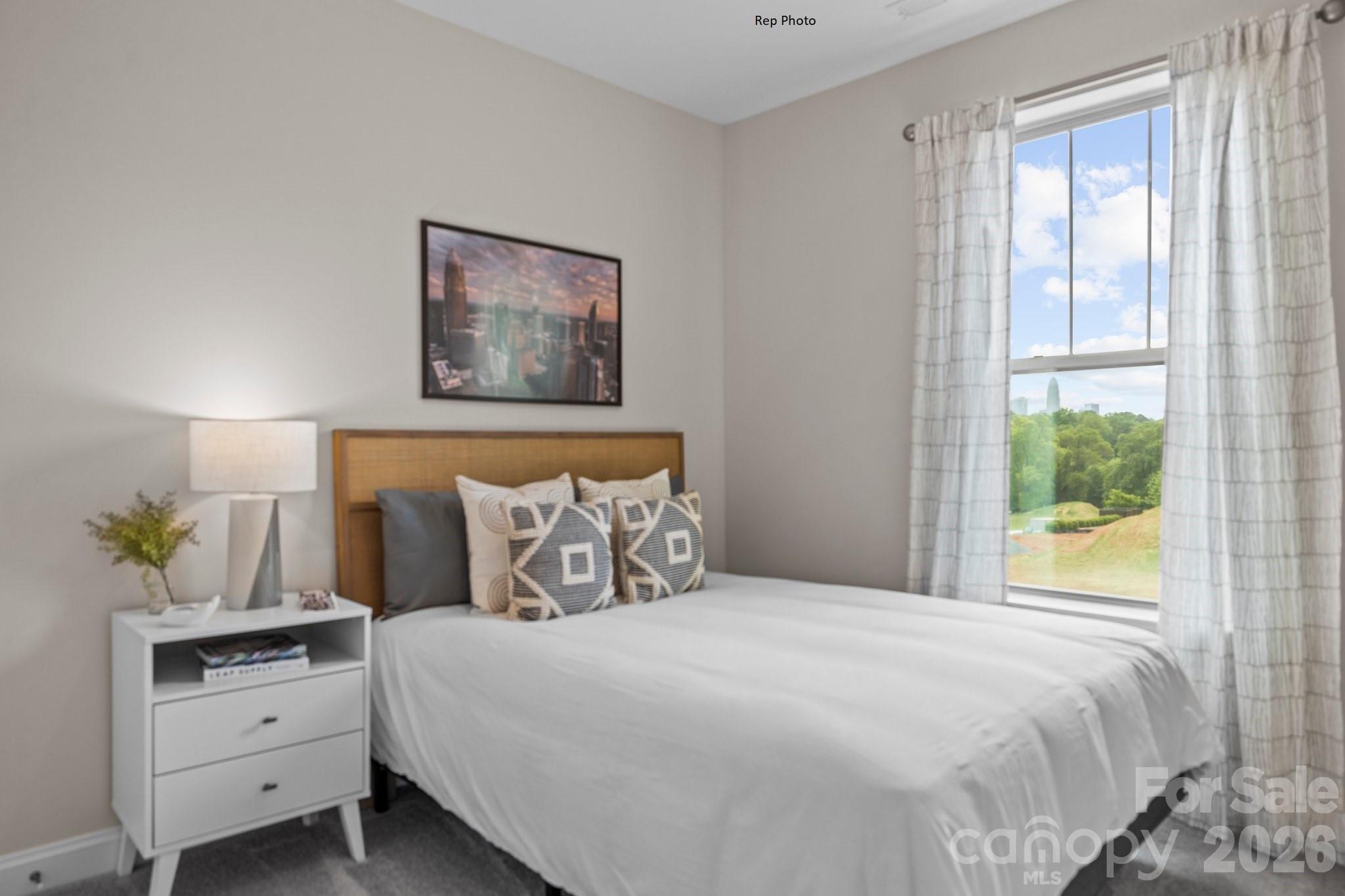3027 Rozzelles Ferry Road Charlotte, NC 28208 - Photo 7 of 16 a bedroom with bed cabinets and window