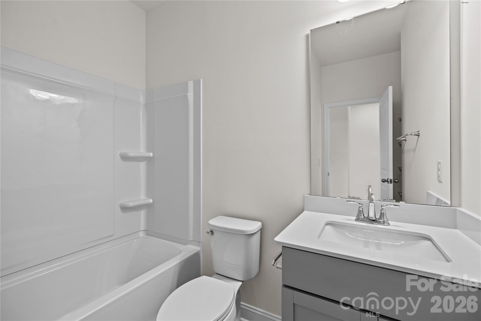 3027 Rozzelles Ferry Road Charlotte, NC 28208 - Photo 10 of 16 a bathroom with a sink toilet vanity and shower