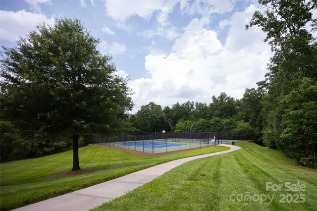 a view of a swimming pool and trees in the background
