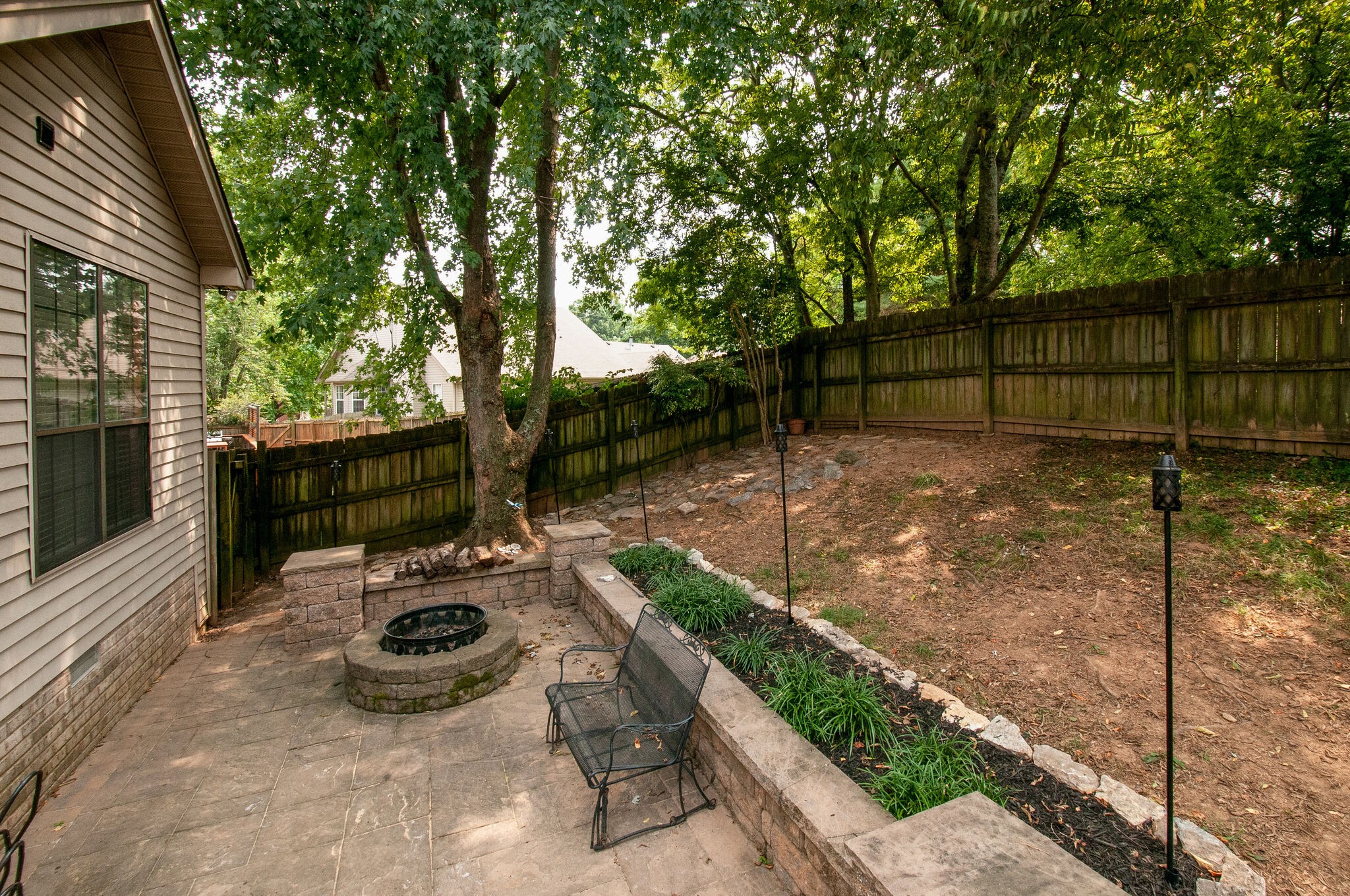 904 Fallview Trail Nashville, TN 37211 - Photo 37 of 38 a view of a backyard with table and chairs potted plants and a house