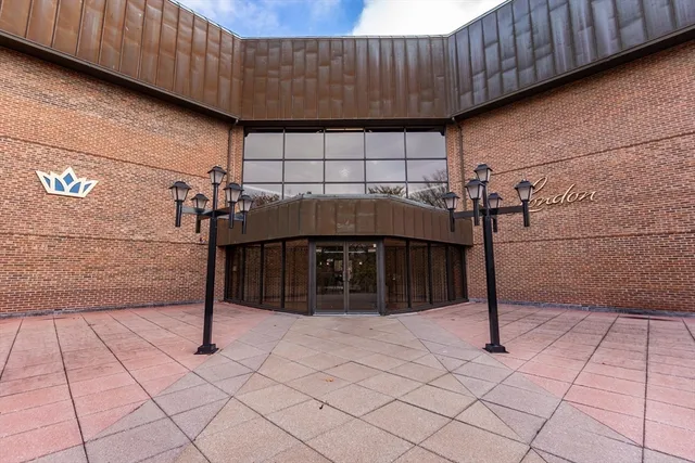 an empty room with windows and cabinet