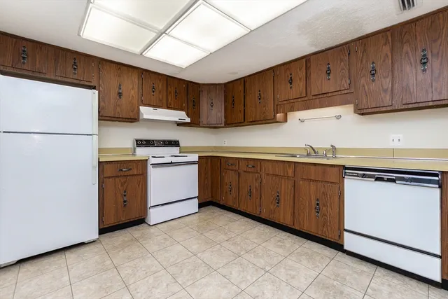 a kitchen with granite countertop cabinets and sink