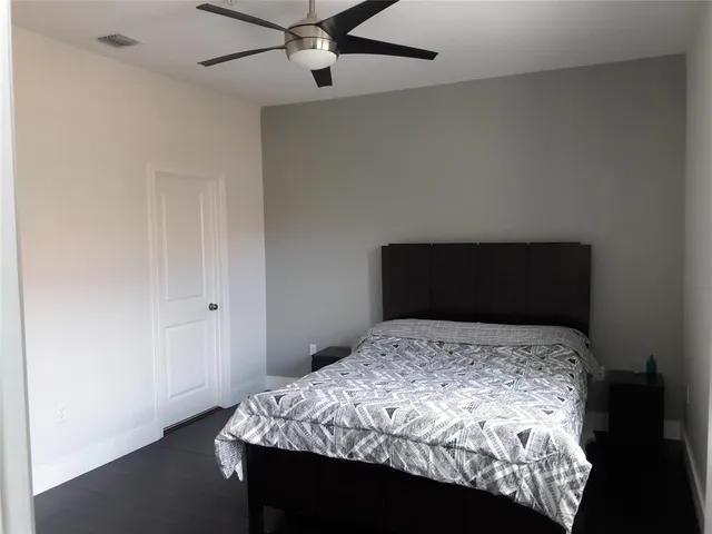 a bedroom with a bed and a table