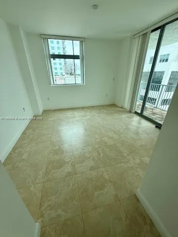 a view of an empty room with a window