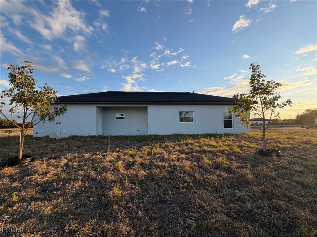 3307 10th Street Southwest Lehigh Acres, FL 33976 - Photo 13 of 13 a backyard of a house with lots of green space