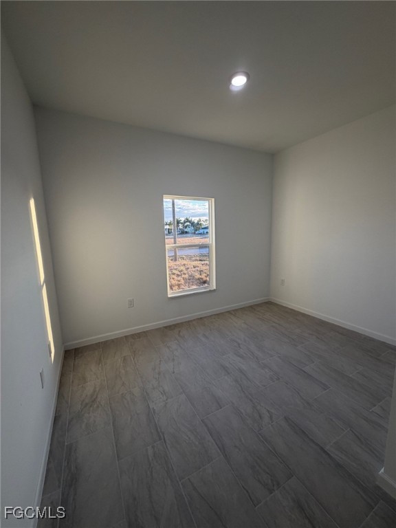 3307 10th Street Southwest Lehigh Acres, FL 33976 - Photo 7 of 13 an empty room with windows