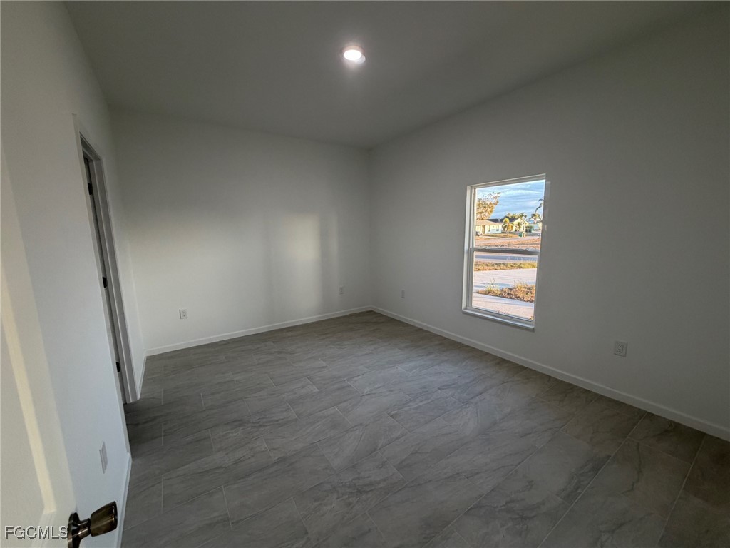 3307 10th Street Southwest Lehigh Acres, FL 33976 - Photo 8 of 13 an empty room with windows